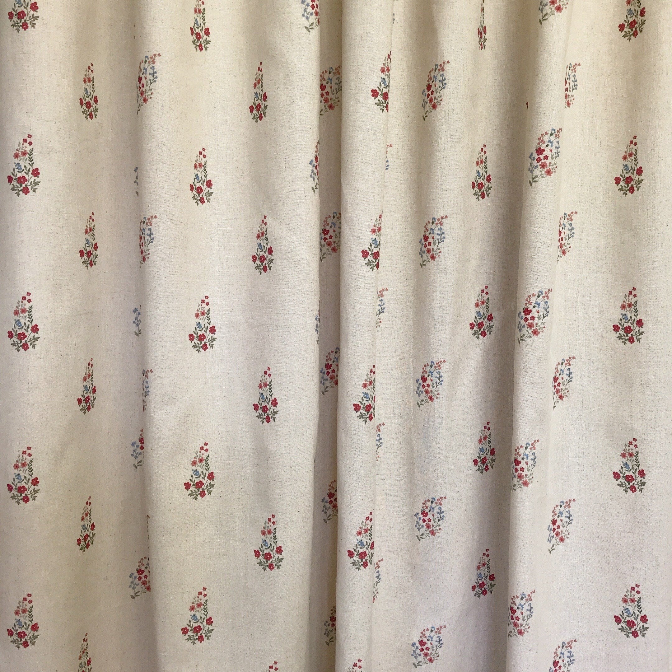 Rideau fleuri rouge et rose framboise sur fond beige naturel