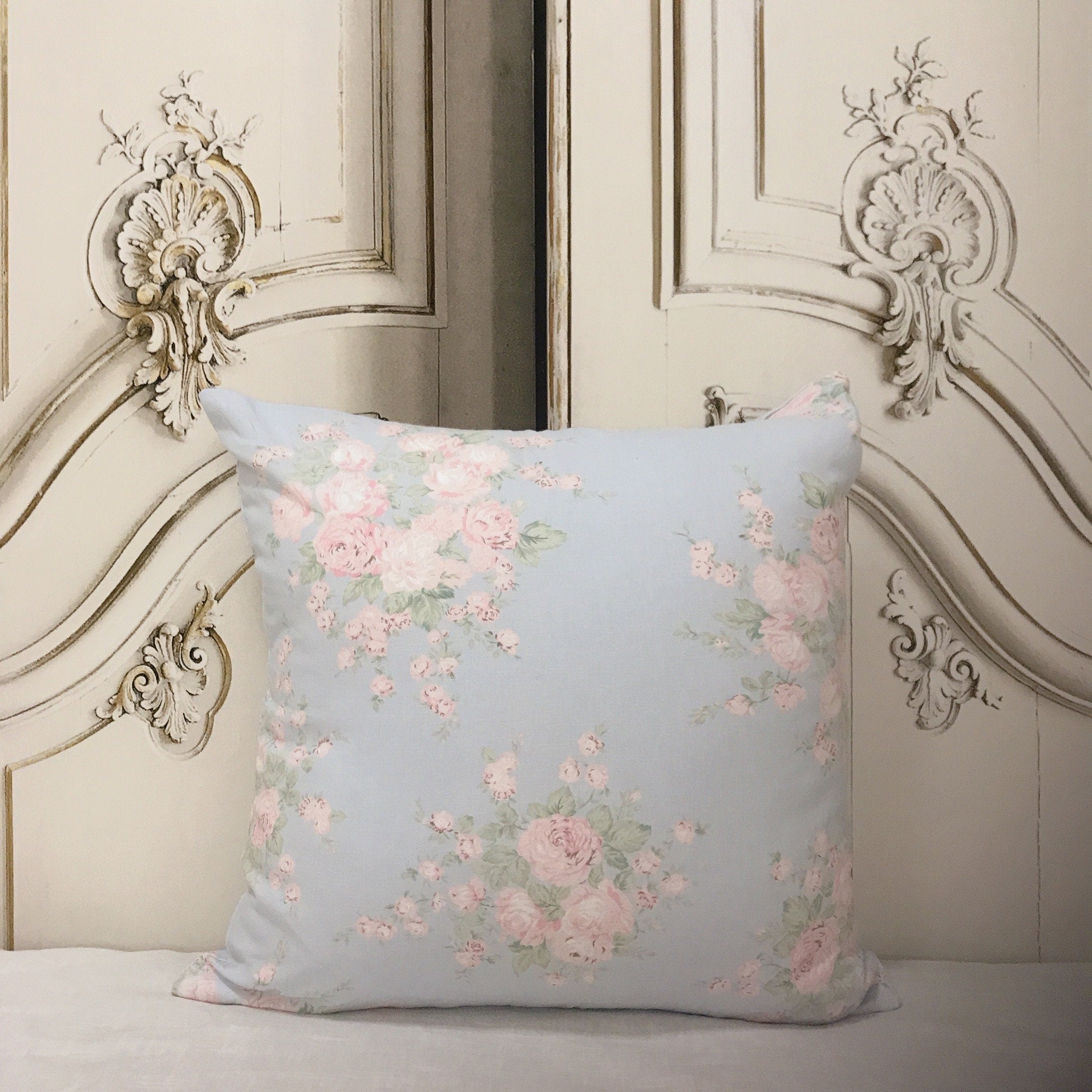 Light Peach and Baby Pink Floral Cushion Cover on Light Blue