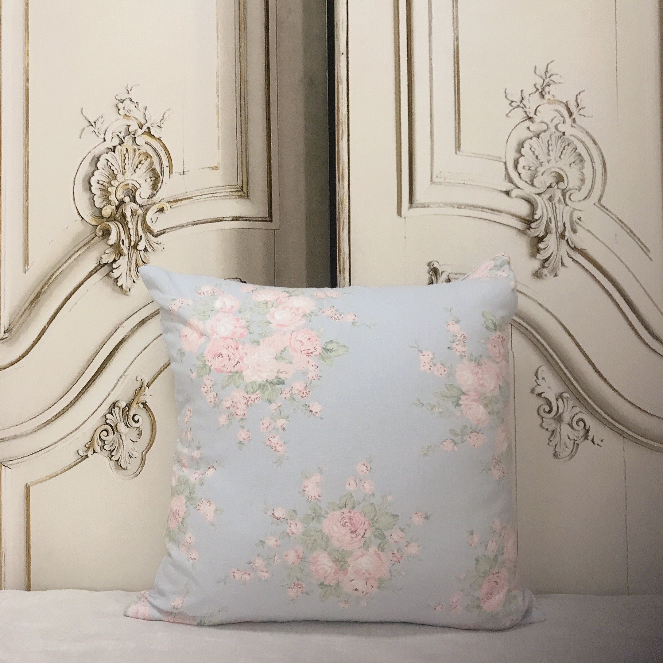 Light Peach and Baby Pink Floral Cushion Cover on Light Blue